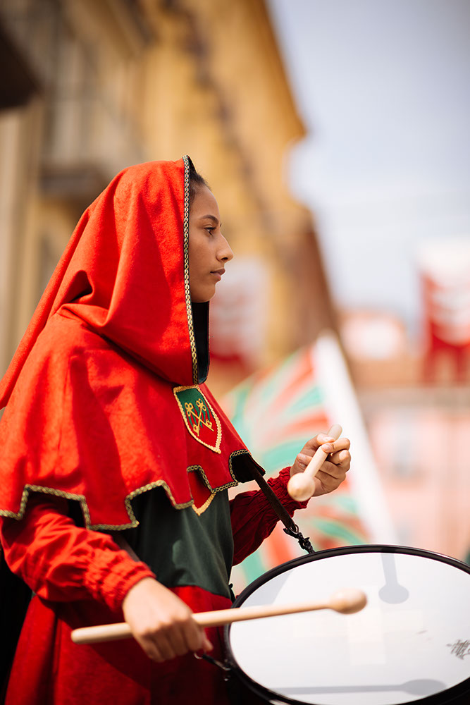 A girl in a medieval costume takes part in a historical parade from the Piazza Cattedrale to the race track ahead of the Palio Di Asti on September 21, 2014 in Asti, Italy